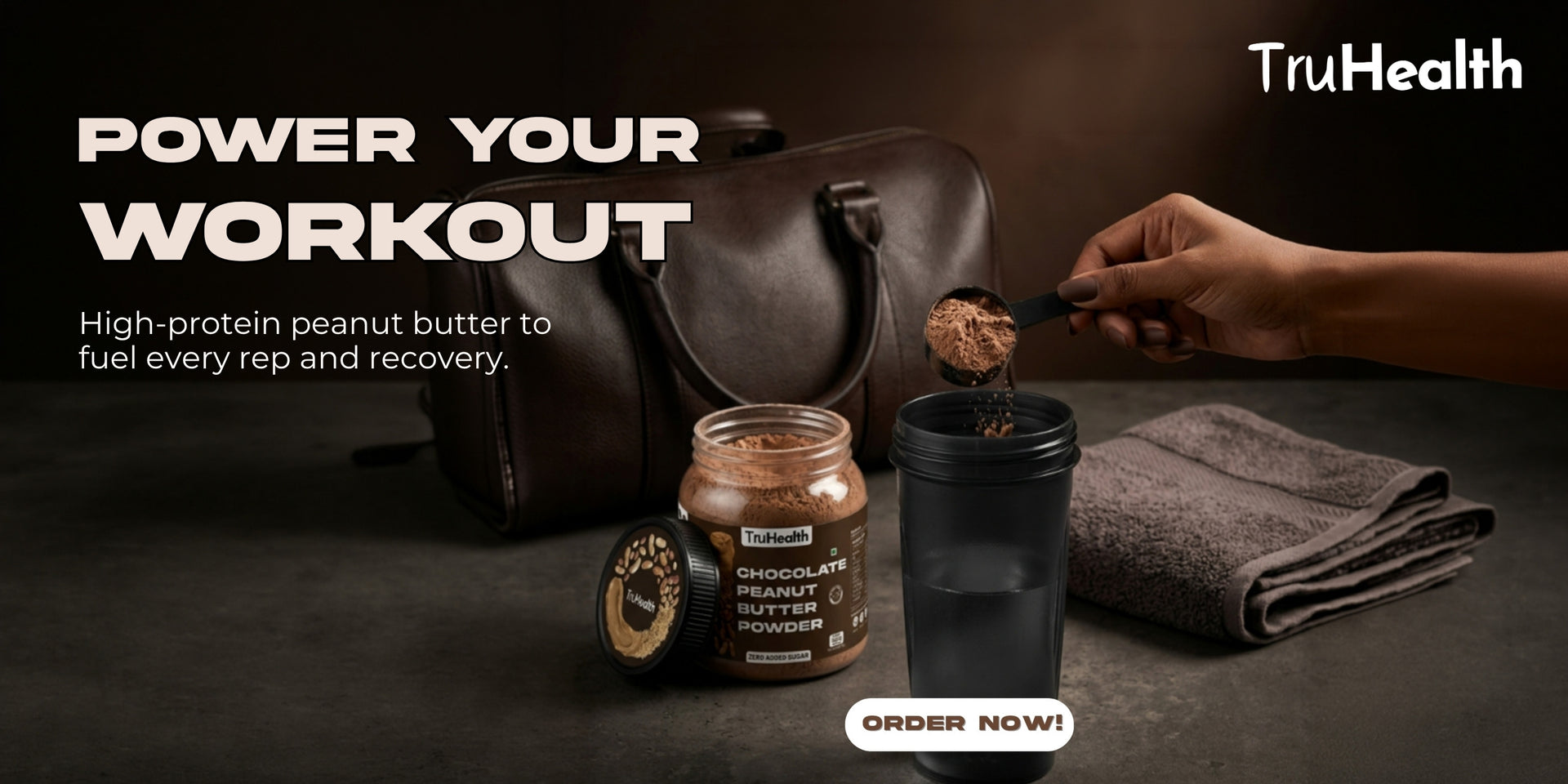 Person scooping high-protein peanut butter into a container with TruHealth branding.